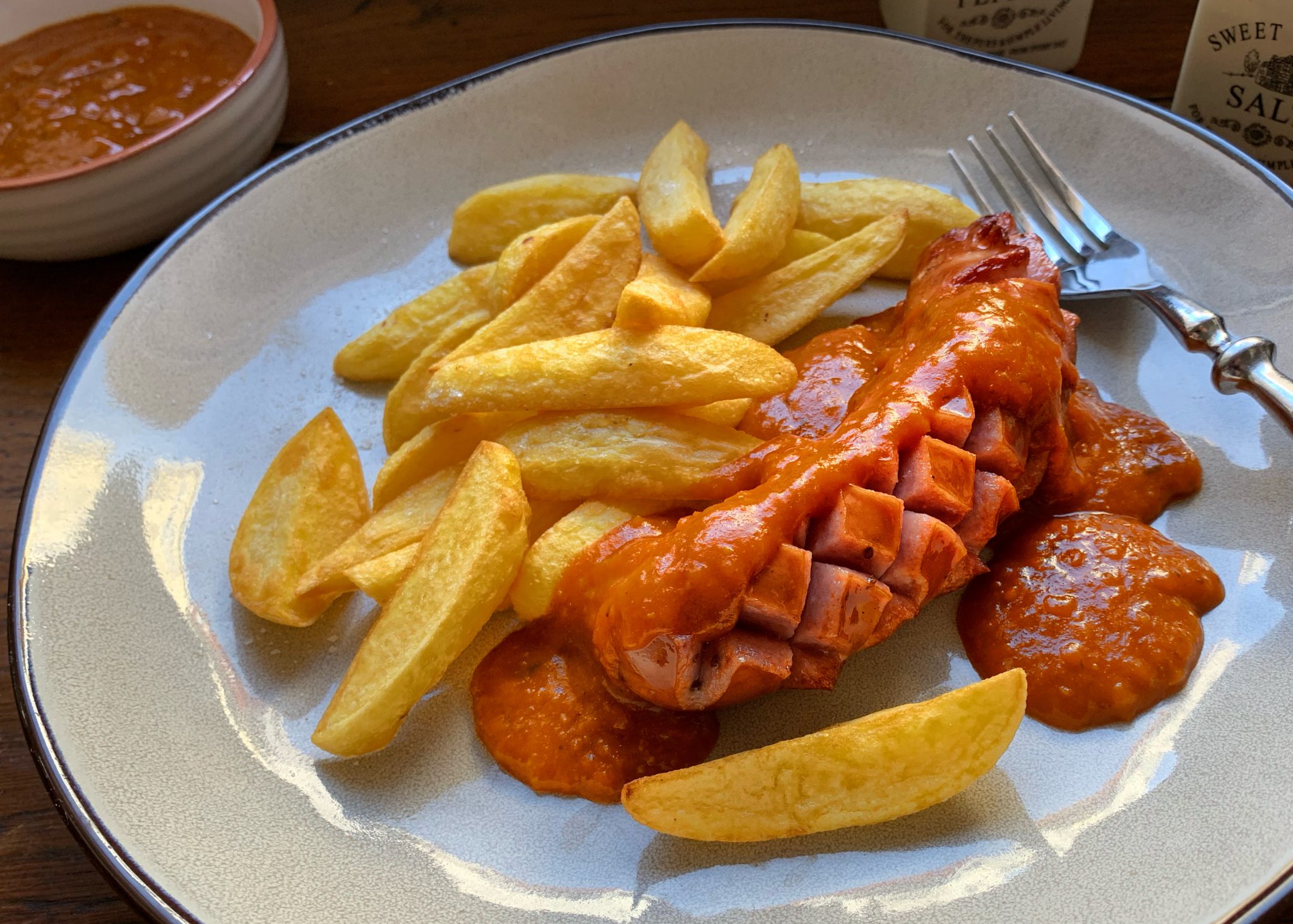 Currywurst mit hausgemachter Currysoße und knusprigen Pommes Schmeck den Süden